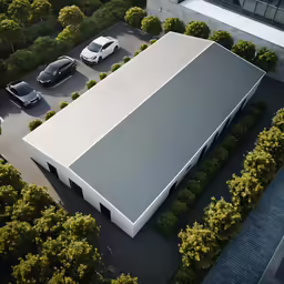 an aerial view of a building with parked cars