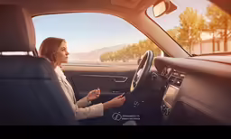 a woman sitting in the passenger seat of a vehicle