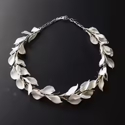 a necklace on black table with a silver chain