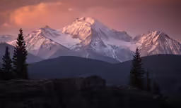 the top of some mountain peaks with snow