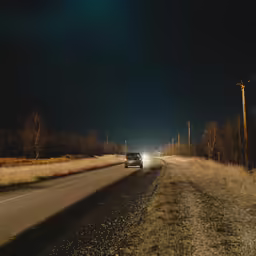 a car is stopped at the speed limit on a road
