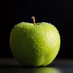 an apple that has water droplets on it