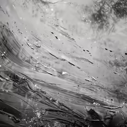 rain drops onto the window pane and light reflected off the glass