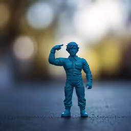 a blue plastic toy that is standing on the ground