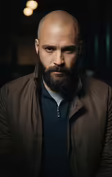 a man with a bald haircut and beard