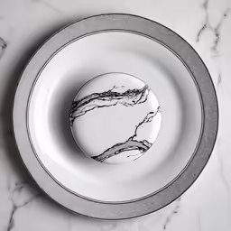 a marble table top with an empty plate in it