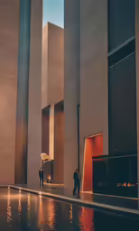 the entrance to a very tall building with lights shining down on the side