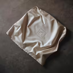 an empty napkin lies on the floor of a dark room