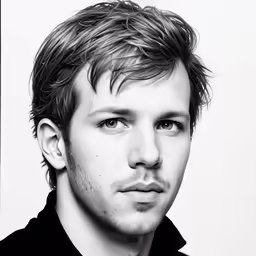 a young man with blonde hair is looking off to the side