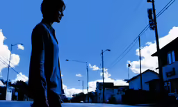 silhouette of man walking down an empty city street