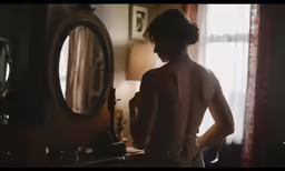 a woman standing in front of a mirror