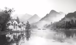 a black and white photo of houses in the woods