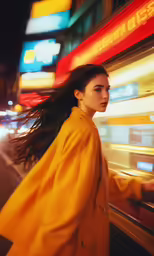 a beautiful woman in a yellow jacket walking down the street
