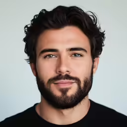 a man with a dark beard wearing a black t - shirt