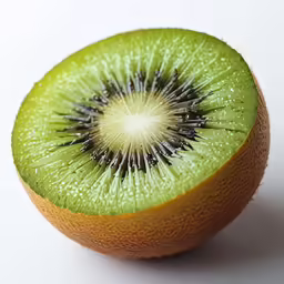 an orange with green leaves and a kiwi cut in half