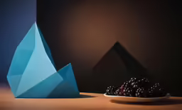 a blue vase that has berries in it near a bowl of blackberries