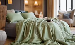 a room with a big bed and a wooden dresser