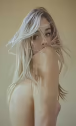 a nude woman with hair flying and flying