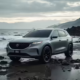 a silver suv parked on top of a beach near the ocean