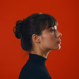 a young woman looking down at something in her hand