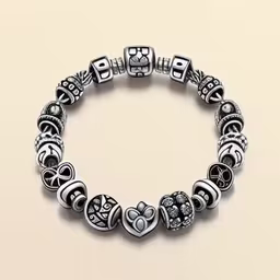 the silver bracelet with beads is shown,a close up of a bracelet on a white surface