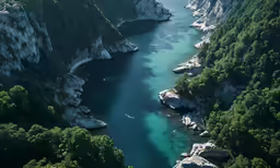 a river flowing between two rocks between cliffs