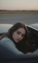 a woman leaning over the window of a car