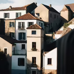 buildings line the hillside as seen from behind