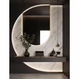 the bathroom counter is surrounded by a large marble mirror