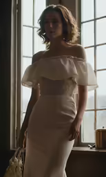 a woman in a wedding dress holding a purse