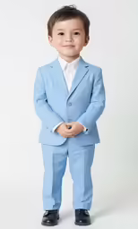 the young child is dressed in a blue suit