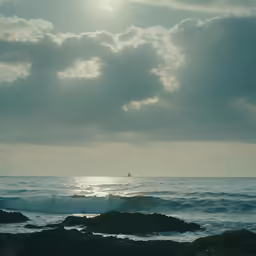 a lone boat on the horizon of an ocean