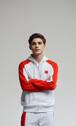 a boy in red and white hoodie posing for a portrait