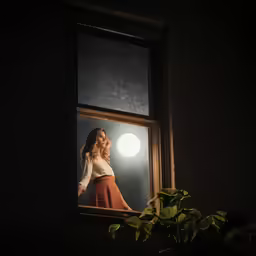 a woman is standing behind the window as the sun shines on her