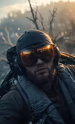 a man in a helmet and goggles standing next to snow