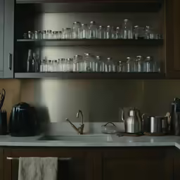 the shelves are filled with tea pots, cups and kettles