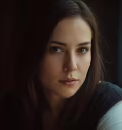 a woman with long hair looking to the side
