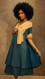 a woman in green dress wearing a gold neck stole