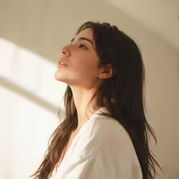 a woman wearing a white shirt and a diamond necklace