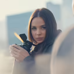 a woman holding a camera and pointing