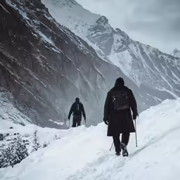 three skiers are hiking up the snow covered hill