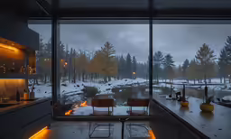 the inside of a glass house overlooking the trees