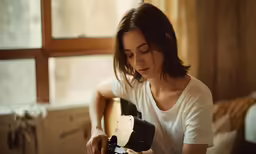 a young woman is photographed taking a picture with her camera