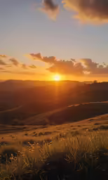 the sun setting on the horizon of some rolling hills