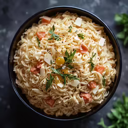 a black bowl is filled with noodle and carrots
