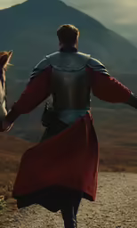 a man in medieval costume walks away from a horse