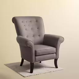 a grey chair on a shaggy white rug