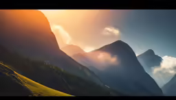 the sun is shining on the mountains and mist