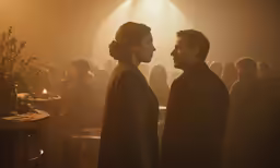 two actors in a dark room, one of them is talking to the other