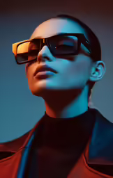 a woman with sunglasses wearing a black suit and red shirt